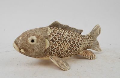 a small wooden fish that is sitting on a table