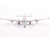 a toy airplane that is on the ground in the snow
