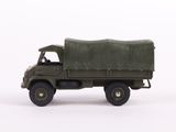 a toy army truck with a green cover on the back