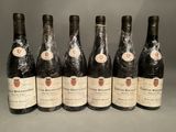 six bottles of wine are lined up in a row on a table