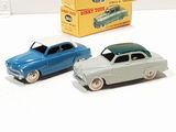 three toy cars sitting next to each other on a table