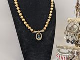necklaces and earrings are displayed on a display stand in a jewelry store