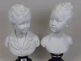 pair of porcelain busts of a boy and a girl