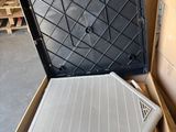 a box with a laptop inside of it sitting on the floor