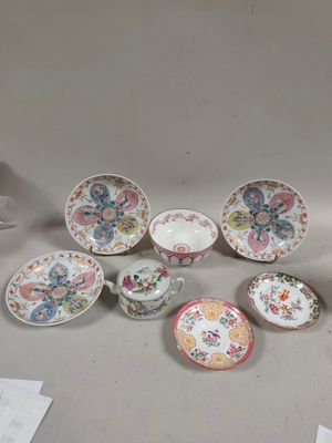many plates and cups sitting on a table with papers