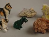 a lot of small figurines of dogs and cats on a table