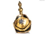 a gold bell with a star on top of it