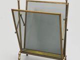 an image of a magazine rack with a mirror on top of it