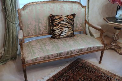 a zebra print pillow on a chair in a room