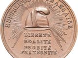 an old bronze medal with a picture of a man ' s hat on it