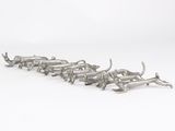 a group of silver metal animals on a white background