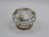 a small glass box with a gold decoration on it