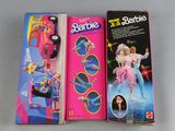 three barbie dolls are sitting on a table next to each other