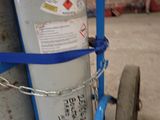 a fire extinguisor sitting on a cart in a garage