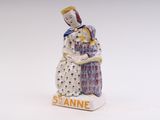 a figurine of a woman sitting on a table