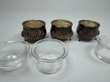three small glass bowls and a small glass bowl on a white surface