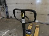 a forklift sitting next to a parking meter in a garage