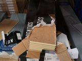 a pile of cardboard and other items on a table