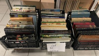 a lot of books that are stacked up on a cart