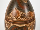 a vase with a design on it sitting on a table