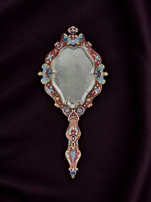 an image of a mirror on a purple cloth
