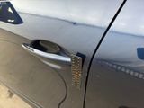 a close up of a car door handle with a sticker on it