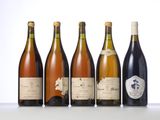 six bottles of wine are lined up on a table
