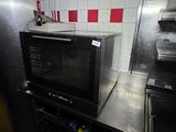 a microwave sitting on top of a counter in a kitchen
