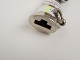 a small metal object that is on a white surface