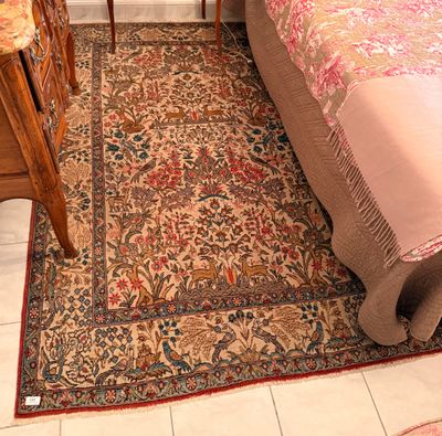 an image of a bedroom with a rug on the floor