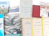 several books are stacked on top of each other on a table