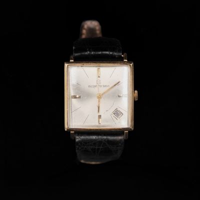 a close up of a watch on a black background