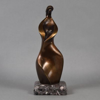 a bronze sculpture of a woman on a marble base