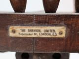 a close up of a wooden chair with a label on it