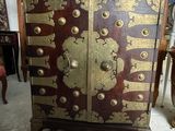 a cabinet that has a gold and red design on it