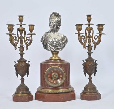a statue of a woman on a pedestal next to three candelabs