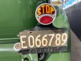 a stop sign on the back of a green car