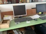 a computer desk with a keyboard and a monitor on it