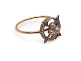 a close up of a gold ring with pearls on it
