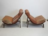 pair of mid - century danish lounge chairs with leather cushions