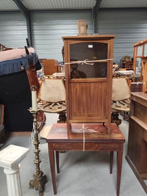 a wooden cabinet with a glass door on top of a table