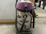 a vacuum that is sitting on the floor in the room