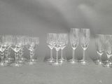 six wine glasses are lined up in a row on a table