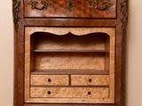 an old wooden cabinet with drawers and a shelf on top of it