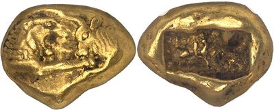 a close up of two gold coins on a white surface