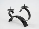pair of black metal candlesticks on a white background