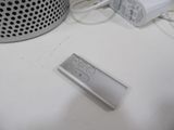 a remote control sitting on a table next to a speaker