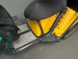 yellow motor scooter with black seat and black seat cover