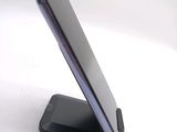 a cell phone on a stand on a white surface