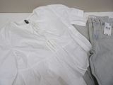 a white shirt, jeans and a pair of shoes on a table